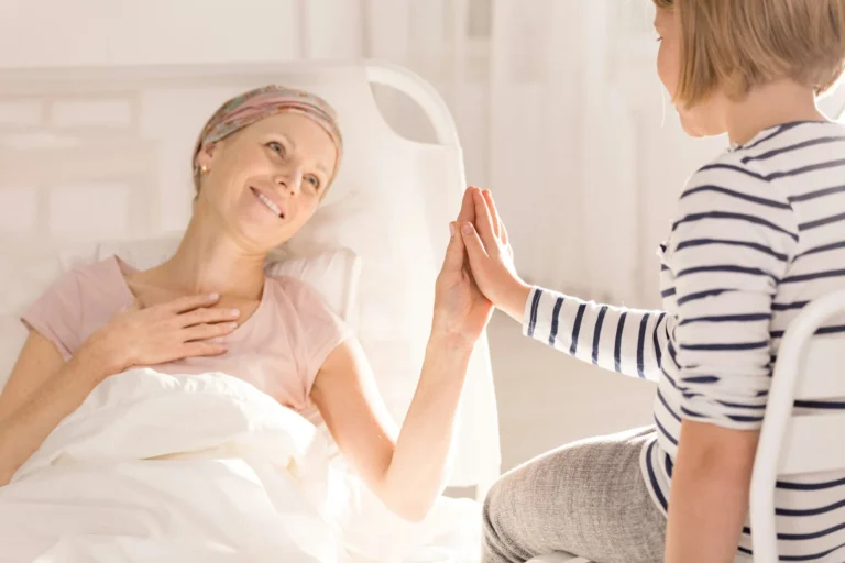 Cancer woman touching child's hand