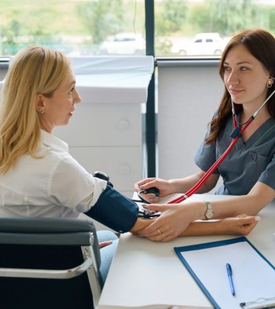 adult-woman-undergoing-routine-health-check-with-family-doctor.jpg